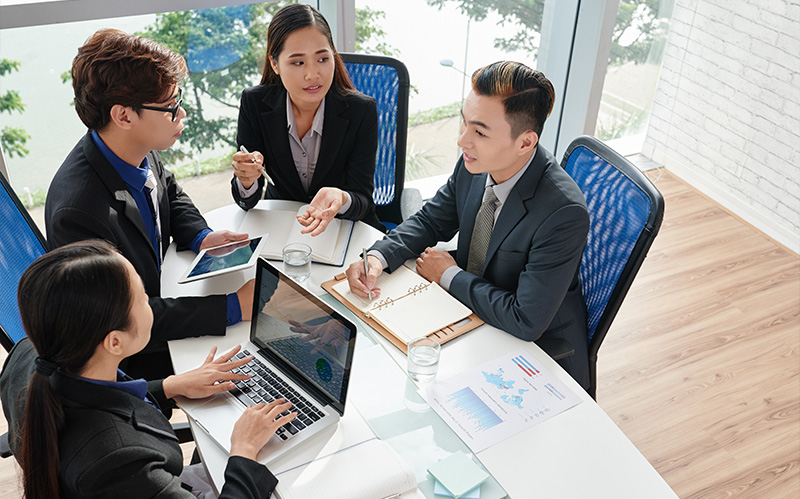 Business team seated at a table discussing strategy