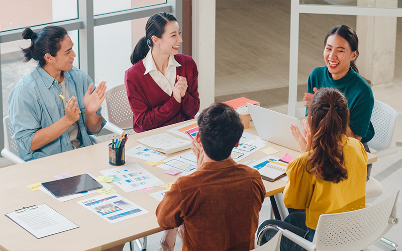 Diverse team clapping during a productive meeting