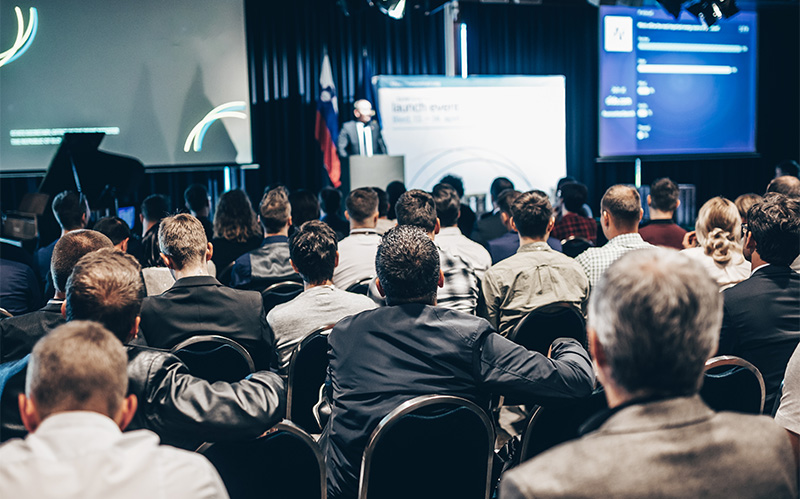 Audience listening to speaker during a large corporate conference