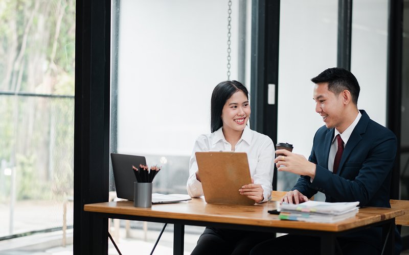 Business-professionals-asking-questions-and-discussing-documents-during-meeting