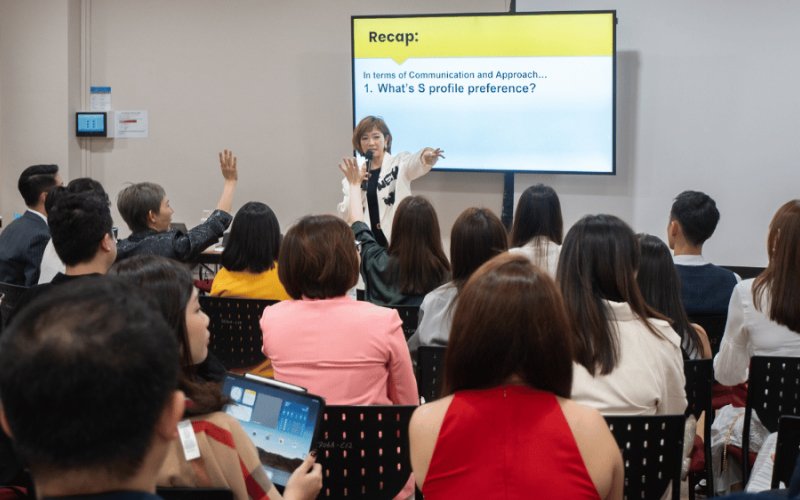 Speaker presenting to engaged attendees during corporate training workshop